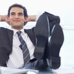 Smiling Businessman Relaxing In His Office